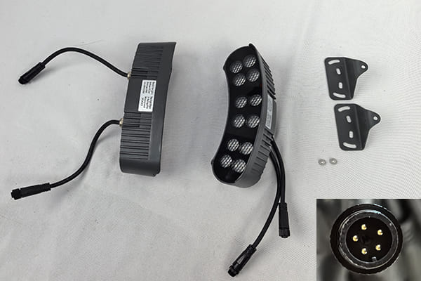 Close-up of a waterproof M12 connector on an LED light fixture